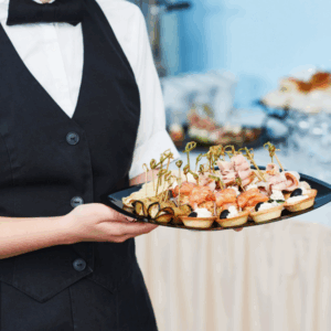Catering staff serving hors d’oeuvres at a wedding reception