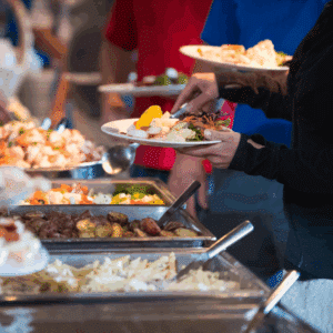Guests serving themselves from a buffet at an event