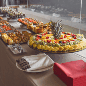 Buffet line with a variety of entrees and side dishes in chafing trays.