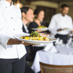 Professional catering staff serving guests at a holiday event