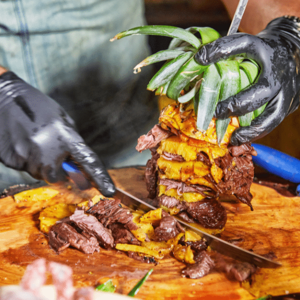Interactive food station with chef serving guests at a corporate party.