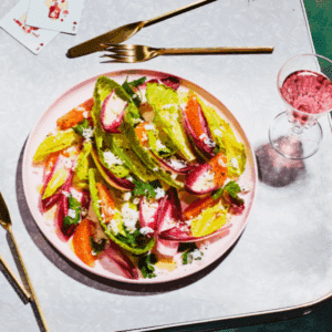 A server presenting a plated entree during a formal catered event.